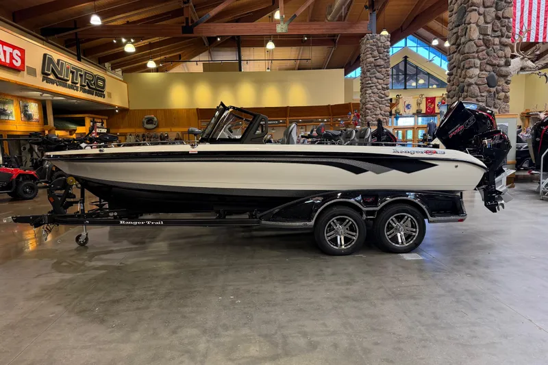 The Image of 2026 Ranger 621FS Cup-Equipped boat on trailer in showroom, featuring sleek design and modern amenities. - 0