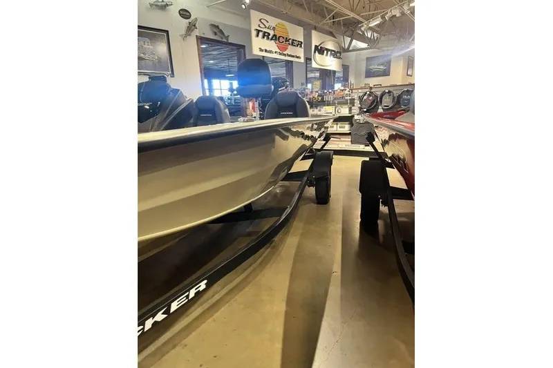 The Image of 2026 Tracker Pro Team 190 boat displayed in a showroom with promotional signage. - 0