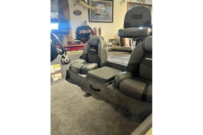 Slide: The Image of Interior of 2026 Tracker Pro Team 190 boat with comfortable seating and steering wheel. - 8
