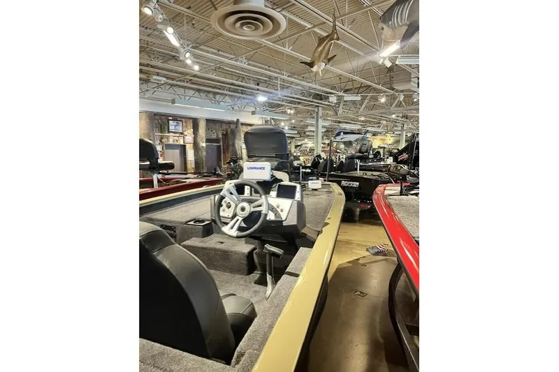 Slide: The Image of 2026 Tracker Pro Team 190 boat interior with steering wheel and controls in showroom. - 7