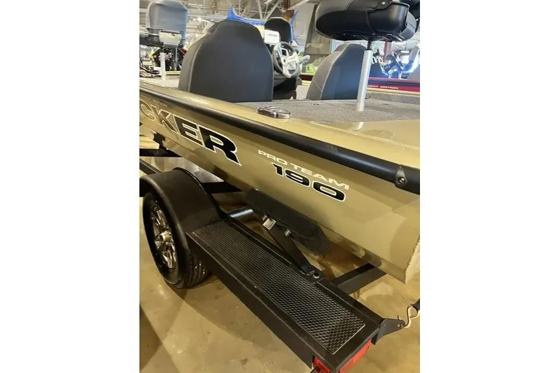 Slide: The Image of 2026 Tracker Pro Team 190 boat, beige color, displayed indoors on a trailer. - 9