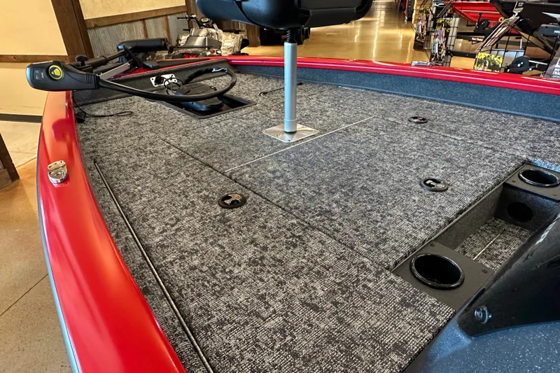 Slide: The Image of 2026 Tracker Pro Team 175 boat interior with carpeted deck and fishing seat. - 13