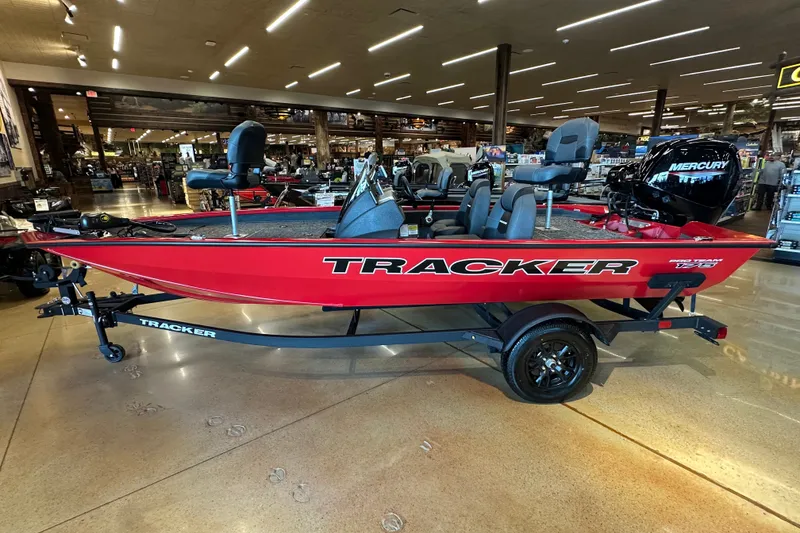 The Image of 2026 Tracker Pro Team 175 boat in showroom, red exterior, on trailer. - 0