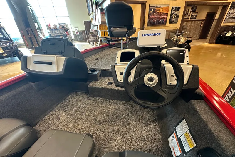 Slide: The Image of 2026 Tracker Pro Team 175 boat interior with steering wheel and Lowrance system. - 18