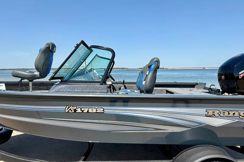 Slide: The Image of 2026 Ranger VS1782SC Reata boat by the water, featuring sleek design and comfortable seating. - 14