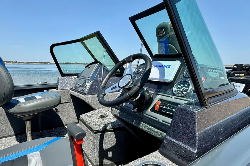 Slide: The Image of 2026 Ranger VS1782SC Reata boat interior with steering wheel and dashboard, on a sunny day. - 6
