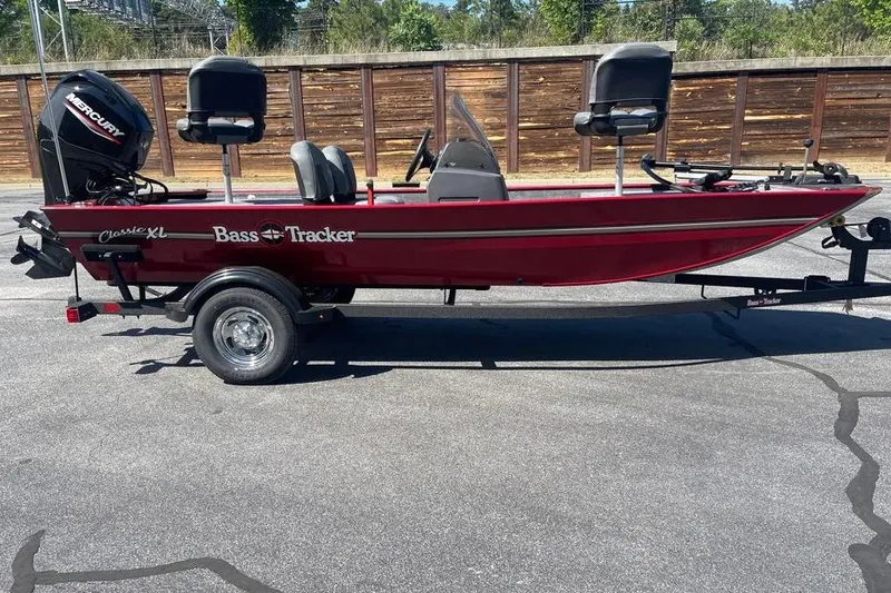 The Image of 2026 Tracker Bass Tracker Classic XL boat on trailer, red exterior, parked outdoors. - 0