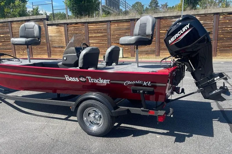 Slide: The Image of 2026 Tracker Bass Tracker Classic XL boat with Mercury outboard motor, parked on trailer. - 4