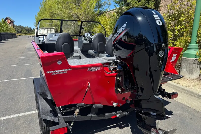 Slide: The Image of 2026 Tracker Pro Guide V-175 WT boat with Mercury 150 engine, parked outdoors. - 3