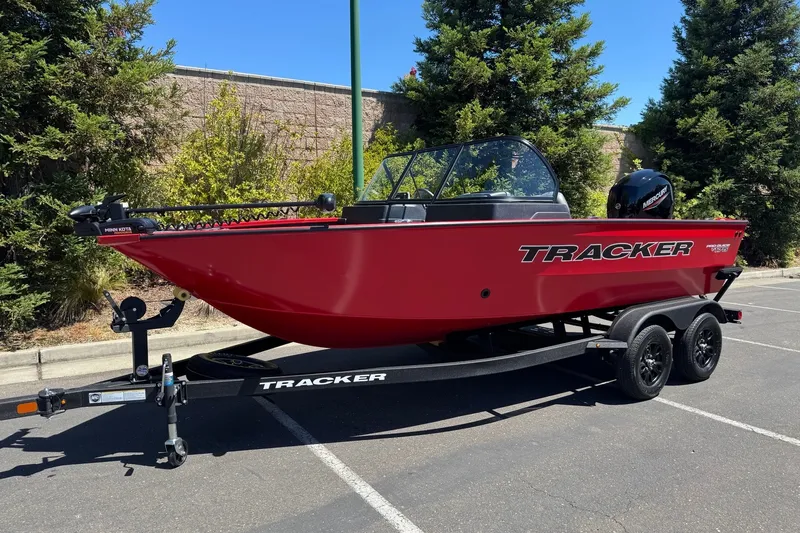 Slide: The Image of 2026 Tracker Pro Guide V-175 WT boat on trailer in parking lot. - 2