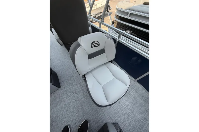 Slide: The Image of 2026 Sun Tracker SportFish 20 DLX boat seat, gray and white upholstery, on deck. - 3