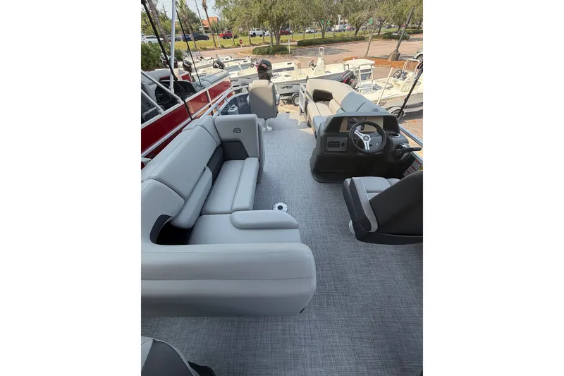 Slide: The Image of 2026 Sun Tracker SportFish 20 DLX pontoon boat interior with plush seating and modern helm. - 2