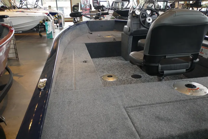 Slide: The Image of 2026 Tracker Super Guide V-16 SC boat interior with seating and steering console. - 3