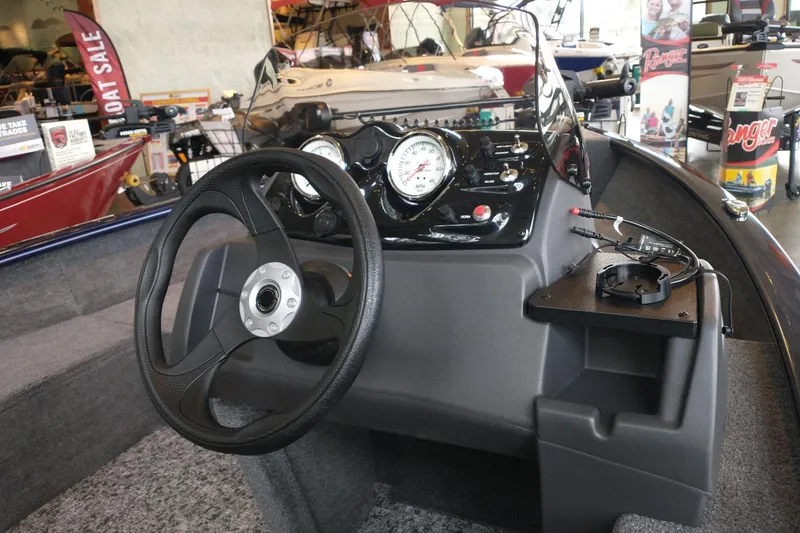 Slide: The Image of 2026 Tracker Super Guide V-16 SC boat dashboard with steering wheel and gauges. - 4