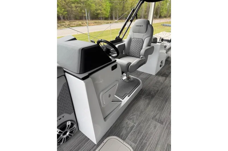 Slide: The Image of 2026 Crest Caribbean 250 SLRC boat interior with modern helm and comfortable seating. - 12