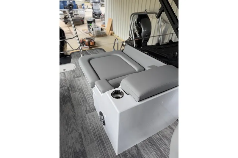 Slide: The Image of 2026 Crest Caribbean 250 SLRC boat interior with gray seating and cup holder. - 16