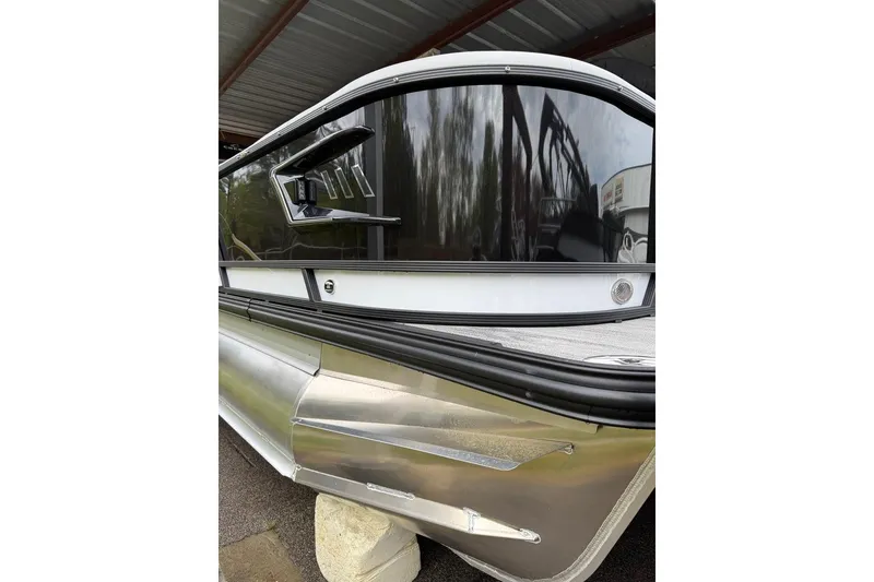 Slide: The Image of 2026 Crest Caribbean 250 SLRC pontoon boat with sleek black and silver design. - 3