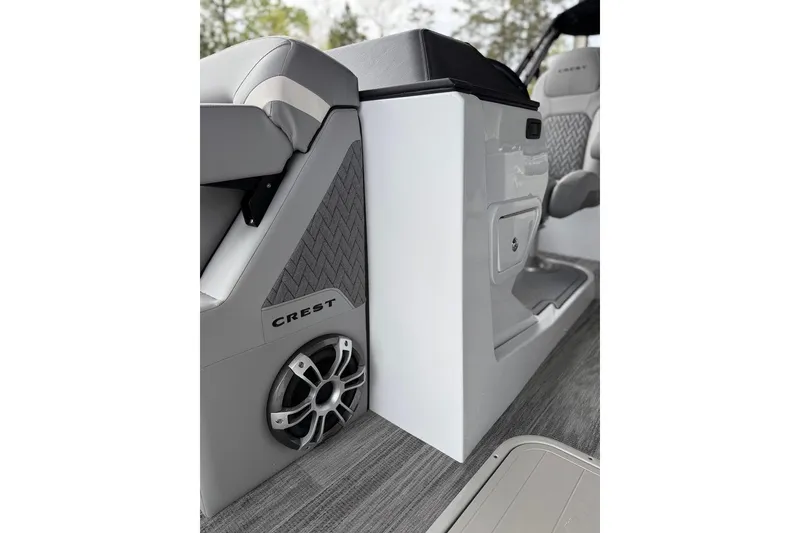Slide: The Image of Interior of 2026 Crest Caribbean 250 SLRC boat, featuring sleek seating and speaker system. - 9