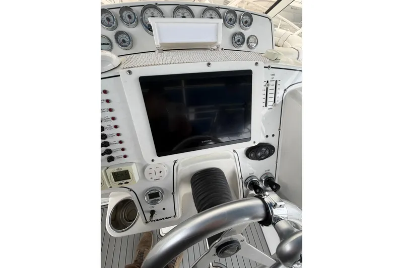 Slide: The Image of Control panel of a 2008 Fountain 33 Sportfish Cruiser with gauges and navigation screen. - 10