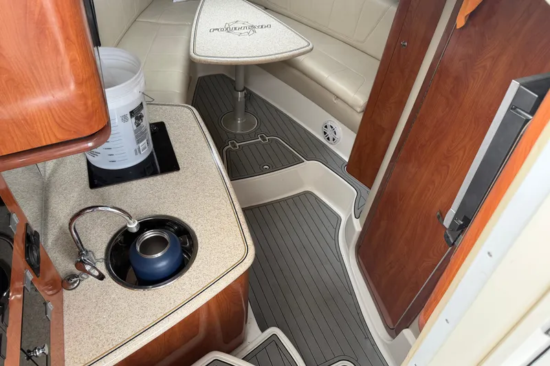 Slide: The Image of 2008 Fountain 33 Sportfish Cruiser interior with kitchenette and seating area. - 11
