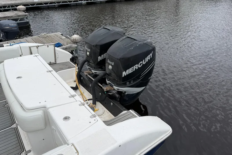 Slide: The Image of 2008 Fountain 33 Sportfish Cruiser with twin Mercury outboard engines docked by the water. - 6