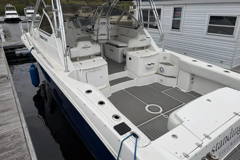 Slide: The Image of 2008 Fountain 33 Sportfish Cruiser docked, showcasing spacious deck and seating area. - 7