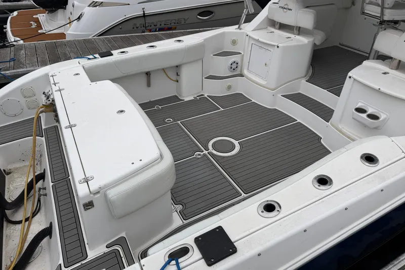 Slide: The Image of 2008 Fountain 33 Sportfish Cruiser boat deck with seating and rod holders. - 8