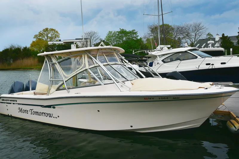 The Image of 2013 Grady-White Freedom 275 boat docked, featuring sleek design and "More Tomorrow" text. - 0