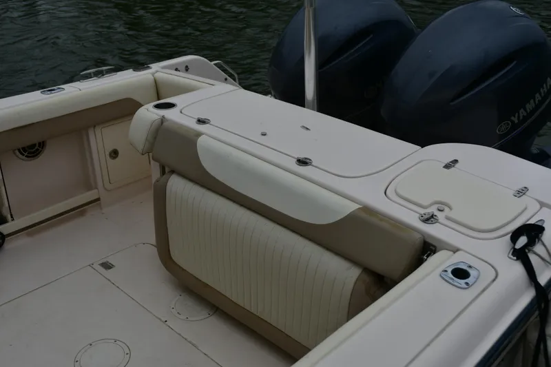 Slide: The Image of 2013 Grady-White Freedom 275 boat interior with Yamaha engines, featuring seating and storage. - 3