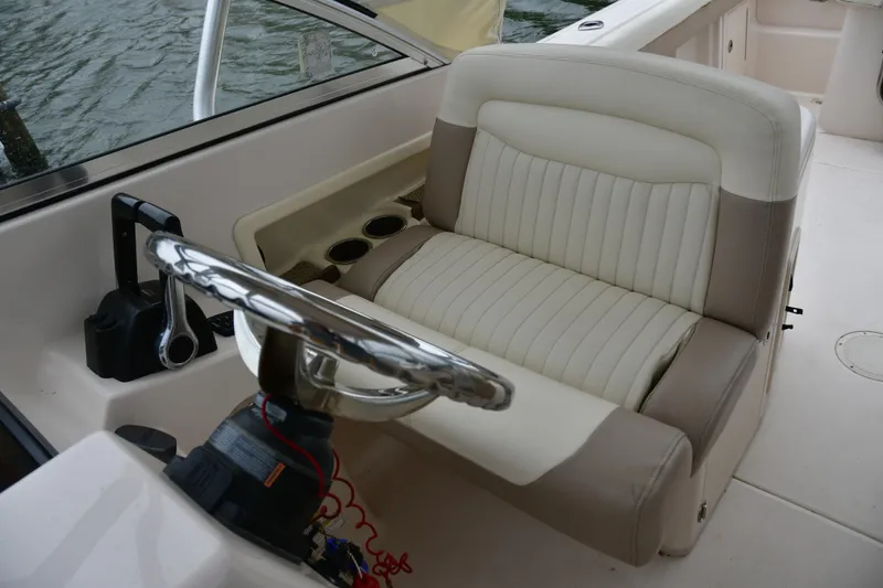 Slide: The Image of Captain's seat and steering wheel of 2013 Grady-White Freedom 275 boat interior. - 5
