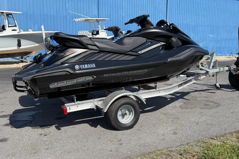 Slide: The Image of 2024 Yamaha WaveRunner FX SVHO on trailer, parked outdoors near blue building. - 12