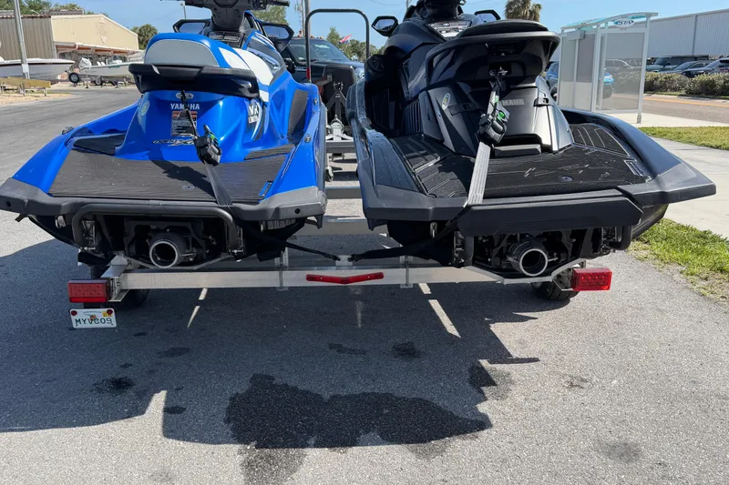 Slide: The Image of 2024 Yamaha WaveRunner FX SVHO jet skis on trailer, blue and black models, parked outdoors. - 14