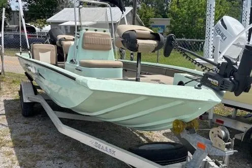 The Image of 2023 Sea Ark 190BX boat on trailer, featuring mint green hull and Suzuki outboard motor. - 1