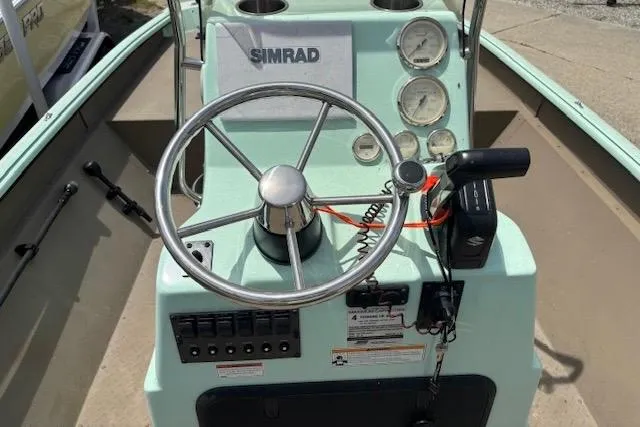 Slide: The Image of Steering console of 2023 Sea Ark 190BX boat with Simrad electronics and gauges. - 2