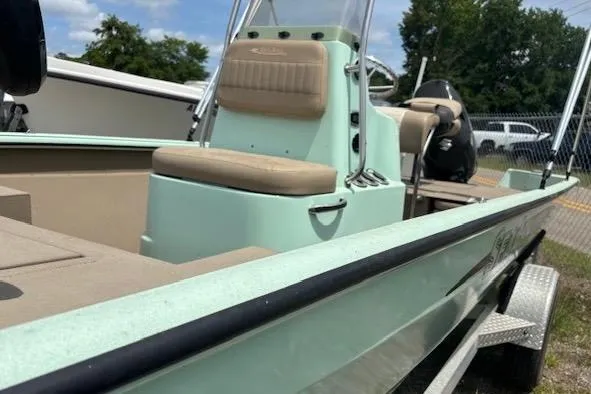 Slide: The Image of 2023 Sea Ark 190BX boat with beige seating, parked on a trailer outdoors. - 4