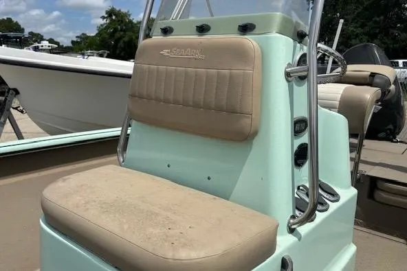 Slide: The Image of 2023 Sea Ark 190BX boat seat with beige cushions and mint green console. - 5