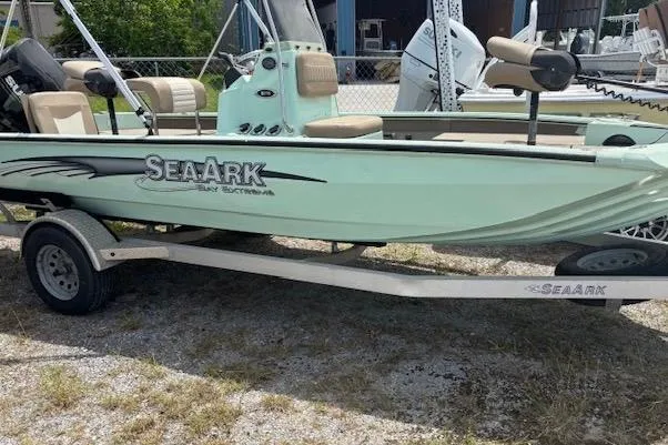 Slide: The Image of 2023 Sea Ark 190BX boat on trailer, light green color, parked outdoors. - 6