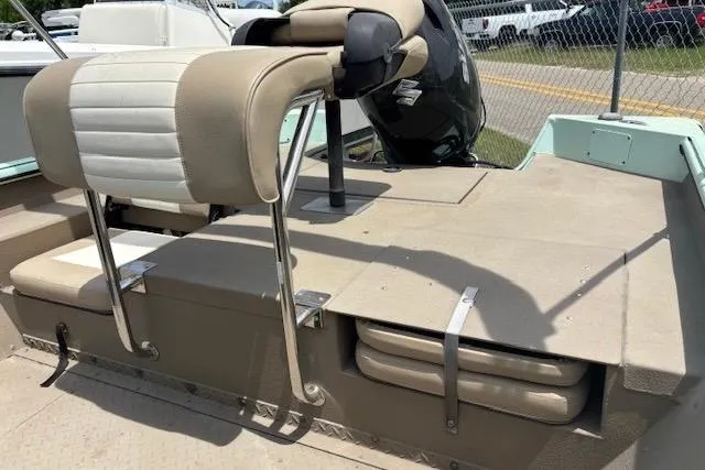 Slide: The Image of 2023 Sea Ark 190BX boat interior with beige seating and storage compartments. - 7