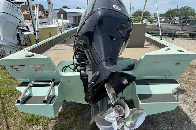 Slide: The Image of 2023 Sea Ark 190BX boat with outboard motor and ladder, displayed outdoors. - 8