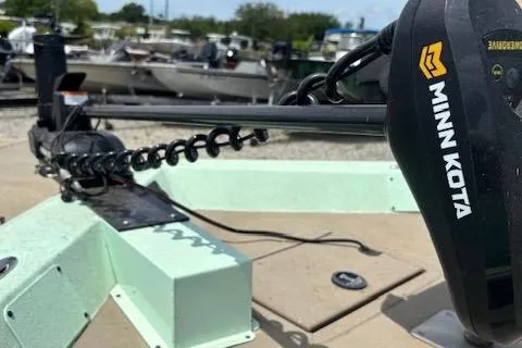 Slide: The Image of 2023 Sea Ark 190BX boat with Minn Kota trolling motor in a marina setting. - 9