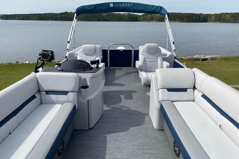 Slide: The Image of 2022 Godfrey Sweetwater 2286 SBX pontoon boat with spacious seating on a serene lake. - 1