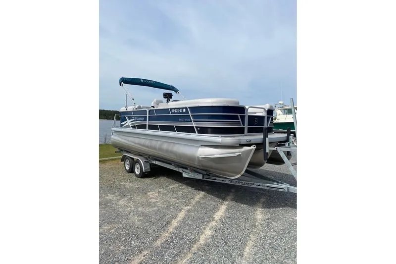 Slide: The Image of 2022 Godfrey Sweetwater 2286 SBX pontoon boat on trailer by a lake. - 13