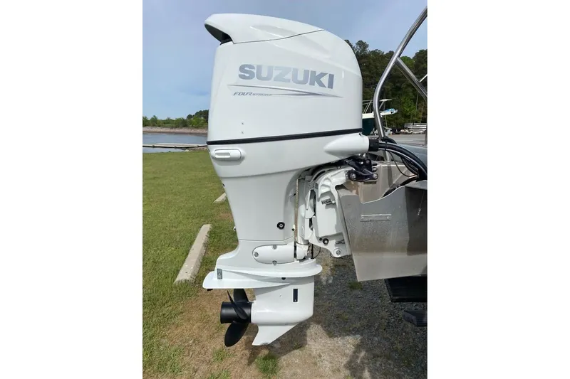 Slide: The Image of Suzuki outboard motor on 2022 Godfrey Sweetwater 2286 SBX pontoon boat, dockside view. - 16