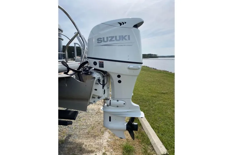 Slide: The Image of 2022 Godfrey Sweetwater 2286 SBX with Suzuki outboard motor by a lakeside. - 17