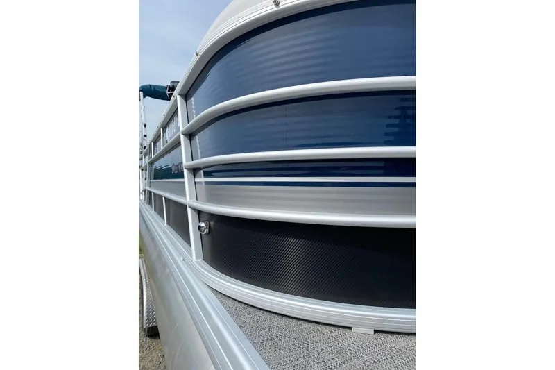Slide: The Image of 2022 Godfrey Sweetwater 2286 SBX pontoon boat with sleek blue and silver exterior design. - 18