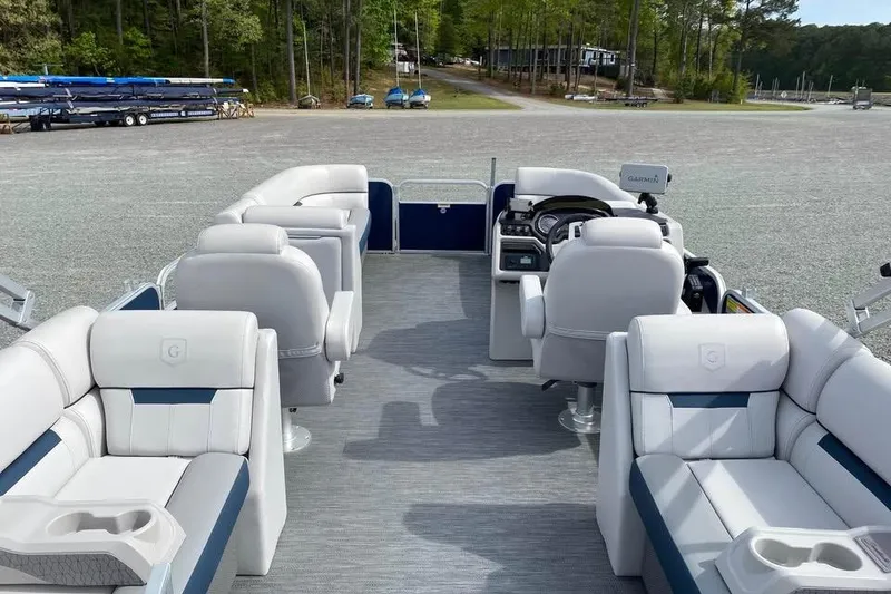 Slide: The Image of 2022 Godfrey Sweetwater 2286 SBX pontoon boat interior with plush seating and steering console. - 2