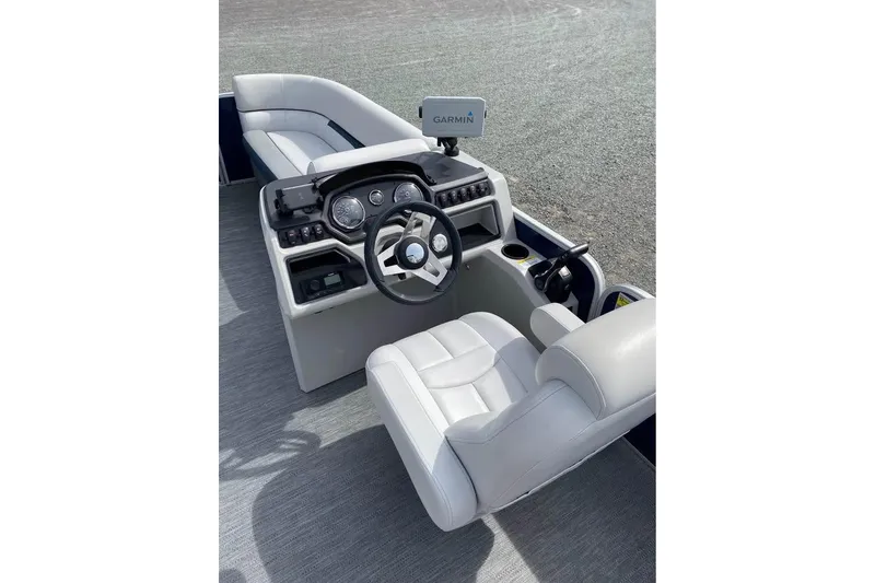 Slide: The Image of 2022 Godfrey Sweetwater 2286 SBX boat interior with steering wheel and Garmin navigation system. - 5