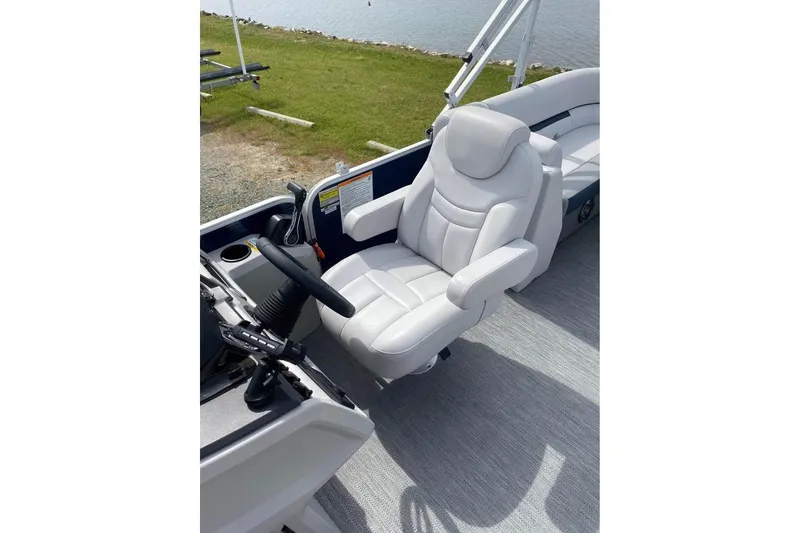 Slide: The Image of Captain's chair on 2022 Godfrey Sweetwater 2286 SBX pontoon boat, near water. - 6