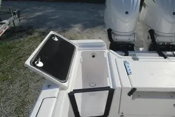 Slide: The Image of 2026 Sea Fox 282 Hybrid LT boat with open storage compartment and dual engines. - 17