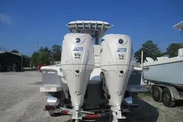 Slide: The Image of 2026 Sea Fox 282 Hybrid LT boat with twin 300 V6 engines, parked outdoors. - 6